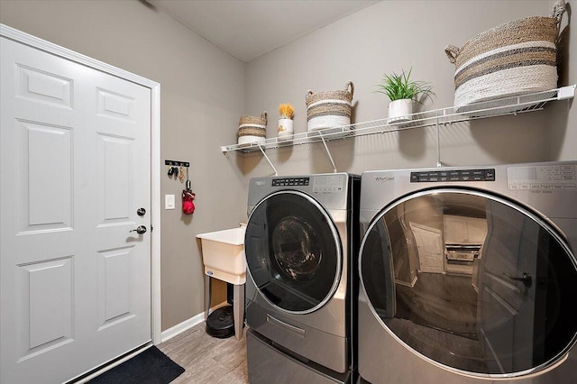 2765 Polson St, Ann Arbor, MI 48105 - washroom featuring separate washer and dryer, light wood finished floors, and baseboards