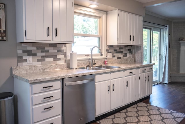 4873 Terrace Ln, Saint Joseph, MI 49085 - kitchen featuring stainless steel dishwasher, a sink, light countertops, crown molding, and white cabinetry