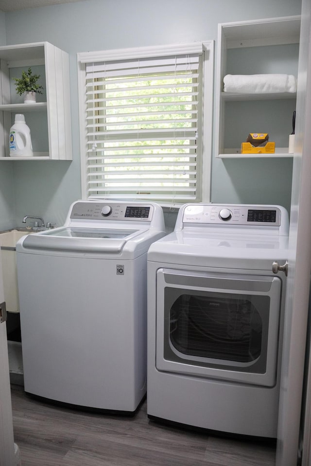 4873 Terrace Ln, Saint Joseph, MI 49085 - laundry area featuring separate washer and dryer and wood finished floors
