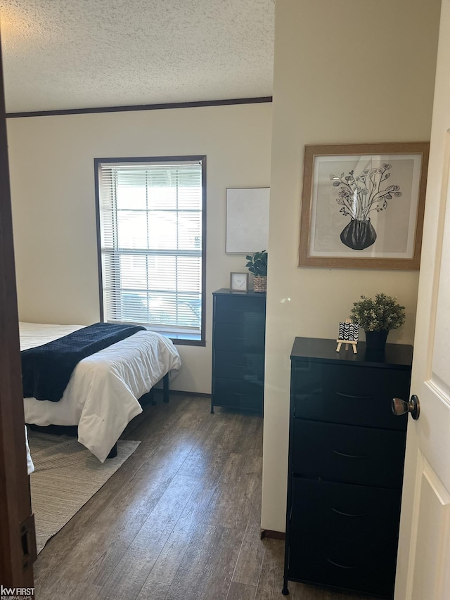 2371 Maple Dr, Fenton, MI 48430 - bedroom featuring dark wood-style flooring and a textured ceiling