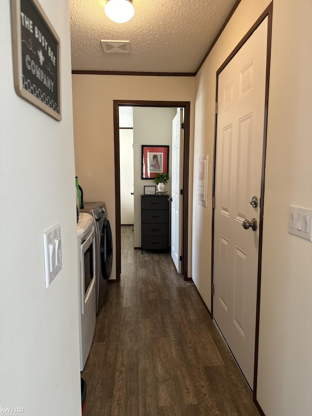 2371 Maple Dr, Fenton, MI 48430 - laundry room featuring washer and clothes dryer, dark wood finished floors, and a textured ceiling