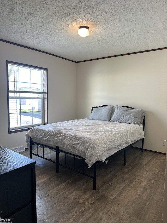 2371 Maple Dr, Fenton, MI 48430 - bedroom with wood finished floors, a textured ceiling, ornamental molding, and baseboards