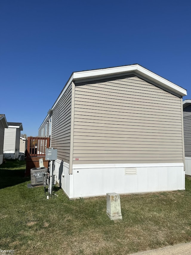 2371 Maple Dr, Fenton, MI 48430 - view of side of property featuring a yard and central air condition unit