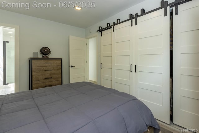 343 Beaupre Ave, Grosse Pointe Farms, MI 48236 - bedroom with a barn door and wood finished floors