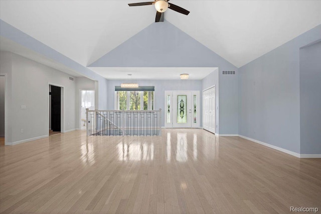12150 Shaffer Rd, Davisburg, MI 48350 - unfurnished living room featuring a ceiling fan, light wood-type flooring, baseboards, and high vaulted ceiling
