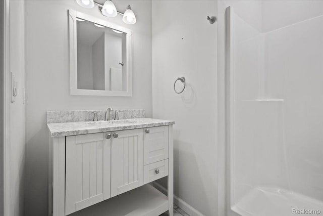 12150 Shaffer Rd, Davisburg, MI 48350 - bathroom with vanity, baseboards, and a shower