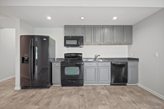 12150 Shaffer Rd, Davisburg, MI 48350 - kitchen with black appliances, a sink, baseboards, gray cabinetry, and light wood-style flooring