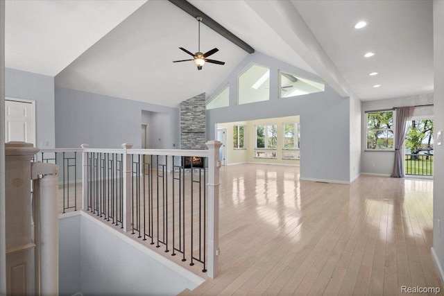 12150 Shaffer Rd, Davisburg, MI 48350 - hall featuring beamed ceiling, high vaulted ceiling, light wood-style floors, an upstairs landing, and baseboards