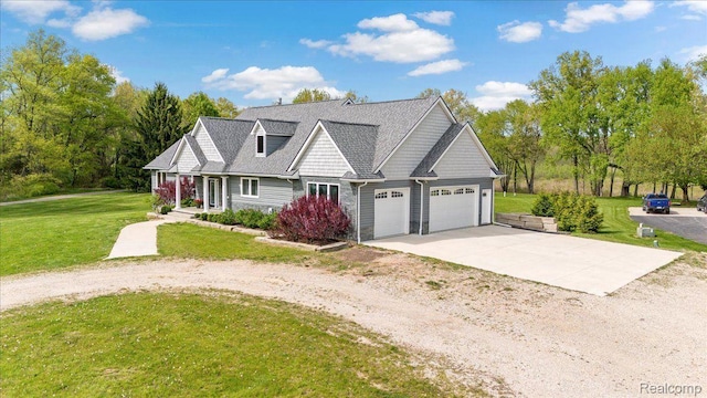 12150 Shaffer Rd, Davisburg, MI 48350 - view of front of home featuring driveway, an attached garage, a front yard, and a porch