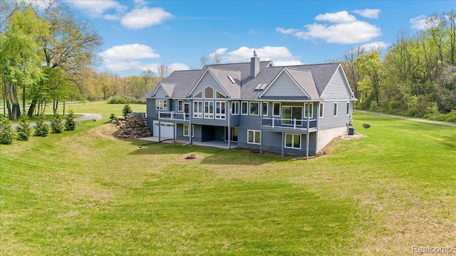 12150 Shaffer Rd, Davisburg, MI 48350 - rear view of property with a lawn, a chimney, an attached garage, and a wooden deck