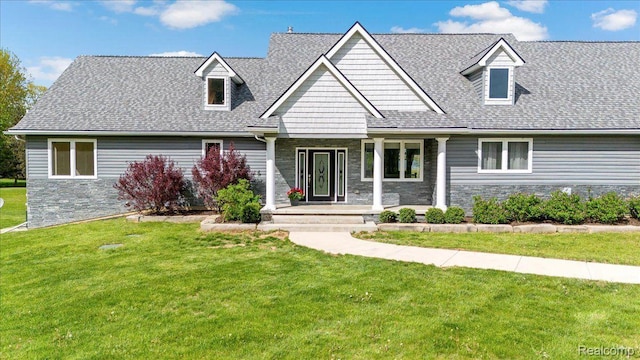 12150 Shaffer Rd, Davisburg, MI 48350 - new england style home with stone siding, covered porch, and a front yard