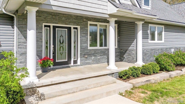 12150 Shaffer Rd, Davisburg, MI 48350 - view of exterior entry featuring a porch and stone siding
