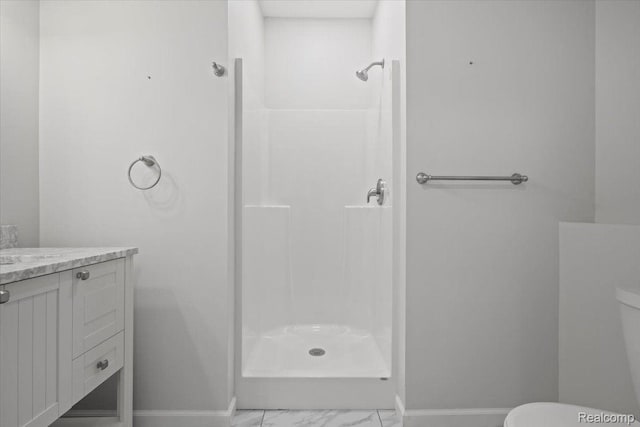 12150 Shaffer Rd, Davisburg, MI 48350 - bathroom featuring toilet, a shower, baseboards, and marble finish floors