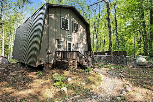 11135 Maple Ridge Way, Roscommon, MI 48653 - view of property exterior featuring a wooden deck and a gambrel roof