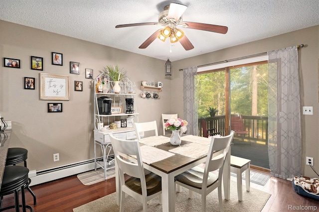 11135 Maple Ridge Way, Roscommon, MI 48653 - dining space featuring baseboard heating, ceiling fan, wood finished floors, and a textured ceiling