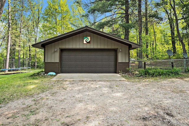 11135 Maple Ridge Way, Roscommon, MI 48653 - detached garage featuring a trampoline