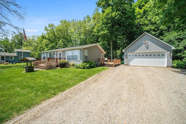 61738 Lake View Dr, Cassopolis, MI 49031 - view of front facade featuring a wooden deck, an outbuilding, a front lawn, driveway, and view of scattered trees