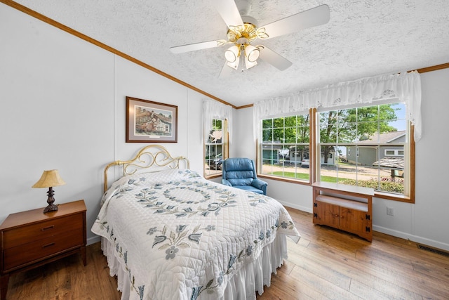61738 Lake View Dr, Cassopolis, MI 49031 - bedroom featuring vaulted ceiling, a textured ceiling, crown molding, hardwood / wood-style flooring, and baseboards
