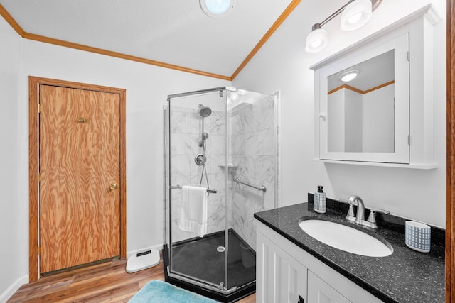61738 Lake View Dr, Cassopolis, MI 49031 - full bathroom featuring ornamental molding, a shower stall, vanity, and wood finished floors