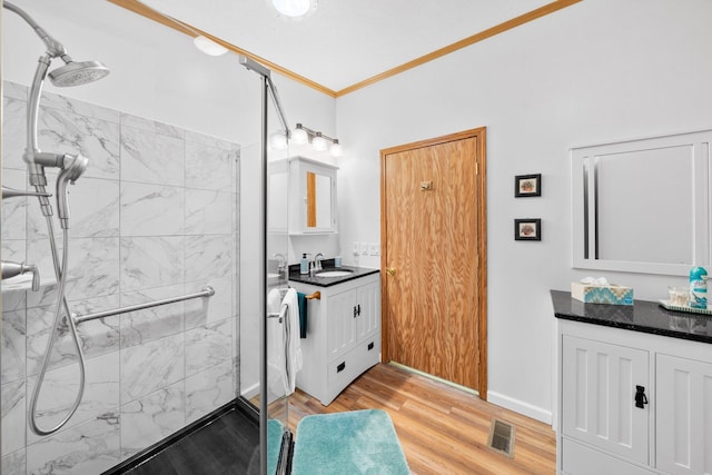 61738 Lake View Dr, Cassopolis, MI 49031 - full bathroom with vanity, a marble finish shower, wood finished floors, and crown molding