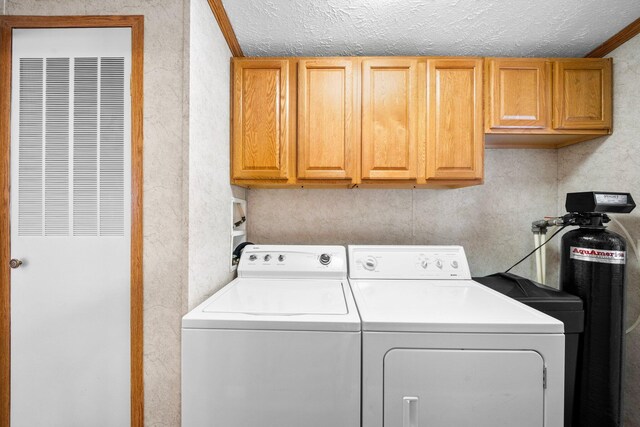 61738 Lake View Dr, Cassopolis, MI 49031 - laundry room featuring a heating unit, washer and dryer, a textured ceiling, and cabinet space