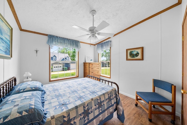 61738 Lake View Dr, Cassopolis, MI 49031 - bedroom featuring crown molding, wood finished floors, a ceiling fan, a textured ceiling, and baseboards