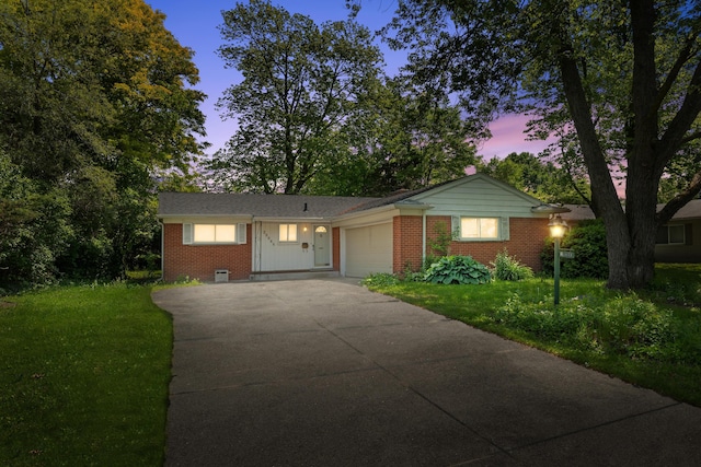 29848 Rambling Rd, Southfield, MI 48076 - ranch-style home featuring concrete driveway, brick siding, an attached garage, and a yard
