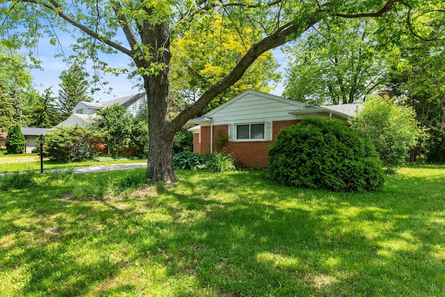 29848 Rambling Rd, Southfield, MI 48076 - view of front of house featuring brick siding, a front yard, and a chimney