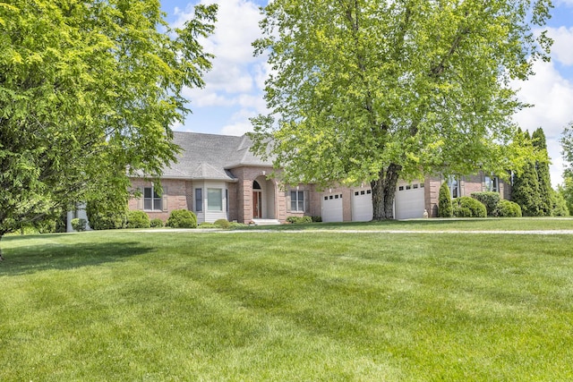 10575 Darrel Dr, Hanover, MI 49241 - view of front of property featuring brick siding, a front lawn, roof with shingles, and a garage
