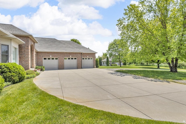 10575 Darrel Dr, Hanover, MI 49241 - view of home's exterior featuring concrete driveway, brick siding, a garage, a lawn, and roof with shingles