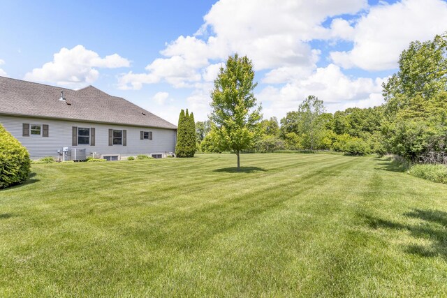 10575 Darrel Dr, Hanover, MI 49241 - view of green lawn featuring central air condition unit