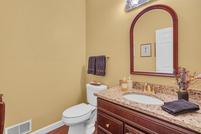 10575 Darrel Dr, Hanover, MI 49241 - bathroom featuring vanity, toilet, baseboards, and wood finished floors