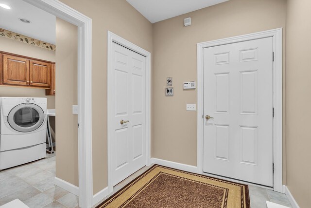 10575 Darrel Dr, Hanover, MI 49241 - laundry room with washer / dryer, cabinet space, and baseboards