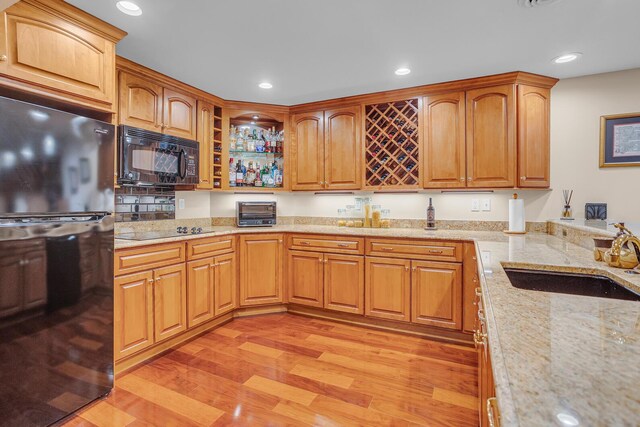 10575 Darrel Dr, Hanover, MI 49241 - kitchen featuring black appliances, a sink, light wood-type flooring, light stone countertops, and recessed lighting