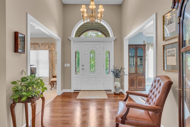 10575 Darrel Dr, Hanover, MI 49241 - entrance foyer featuring a chandelier, wood finished floors, healthy amount of natural light, and a towering ceiling