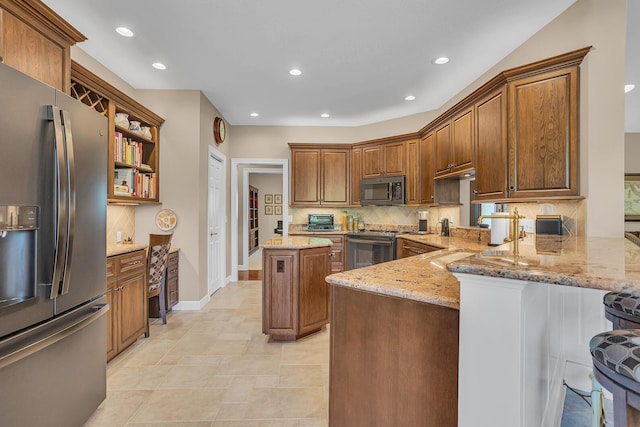 10575 Darrel Dr, Hanover, MI 49241 - kitchen featuring appliances with stainless steel finishes, backsplash, light stone countertops, a peninsula, and recessed lighting