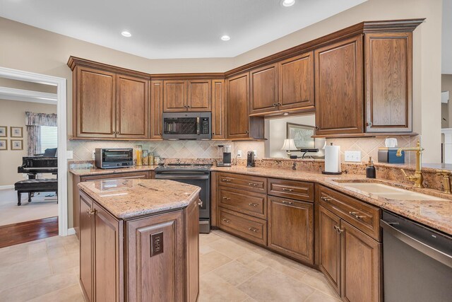 10575 Darrel Dr, Hanover, MI 49241 - kitchen with appliances with stainless steel finishes, a sink, light stone counters, a kitchen island, and backsplash