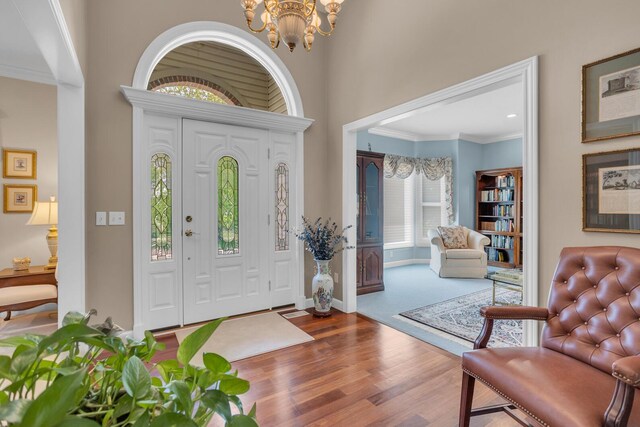 10575 Darrel Dr, Hanover, MI 49241 - foyer featuring a chandelier, wood finished floors, and ornamental molding