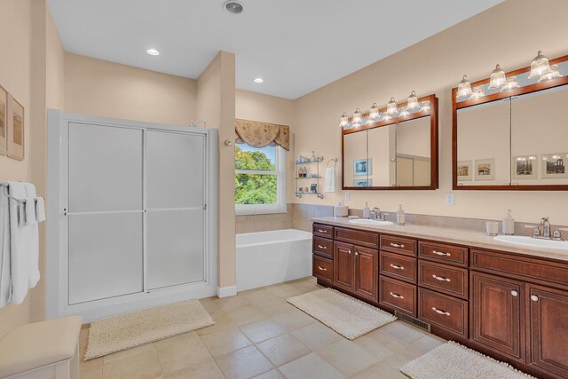 10575 Darrel Dr, Hanover, MI 49241 - bathroom with double vanity, a garden tub, and tile patterned floors