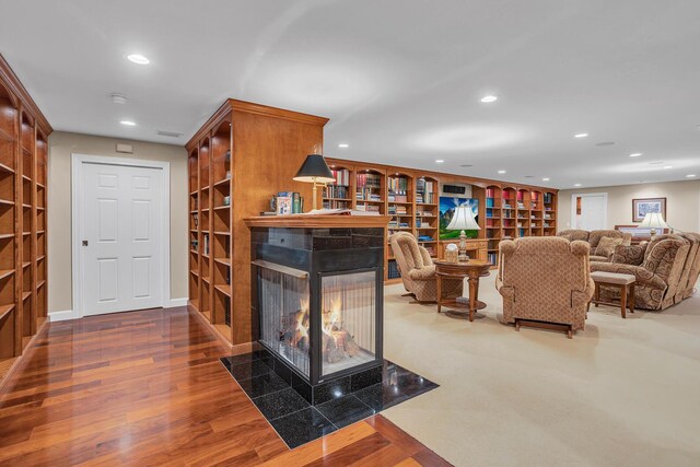 10575 Darrel Dr, Hanover, MI 49241 - living room with recessed lighting, built in shelves, a multi sided fireplace, and wood finished floors