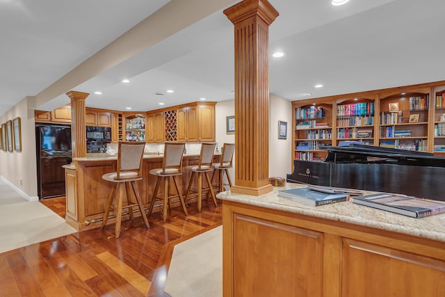 10575 Darrel Dr, Hanover, MI 49241 - office space featuring ornate columns, light wood-style floors, bar area, and recessed lighting