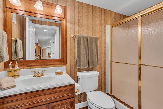 10575 Darrel Dr, Hanover, MI 49241 - bathroom with wallpapered walls, toilet, vanity, and a stall shower
