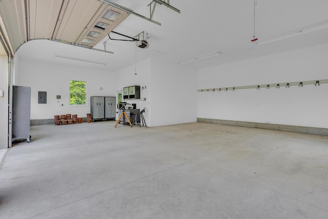10575 Darrel Dr, Hanover, MI 49241 - garage featuring a garage door opener and electric panel