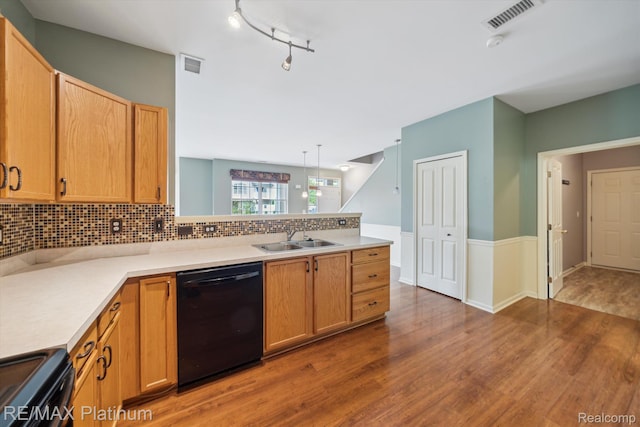 4300 Hampton Ridge Blvd, Howell, MI 48843 - kitchen with black appliances, a sink, wood finished floors, a peninsula, and backsplash