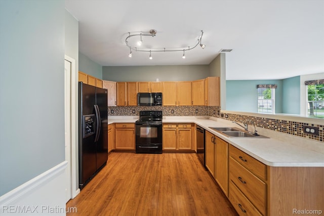 4300 Hampton Ridge Blvd, Howell, MI 48843 - kitchen with black appliances, a sink, light wood finished floors, and light countertops