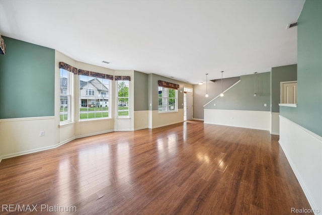 4300 Hampton Ridge Blvd, Howell, MI 48843 - unfurnished living room with wood finished floors and baseboards