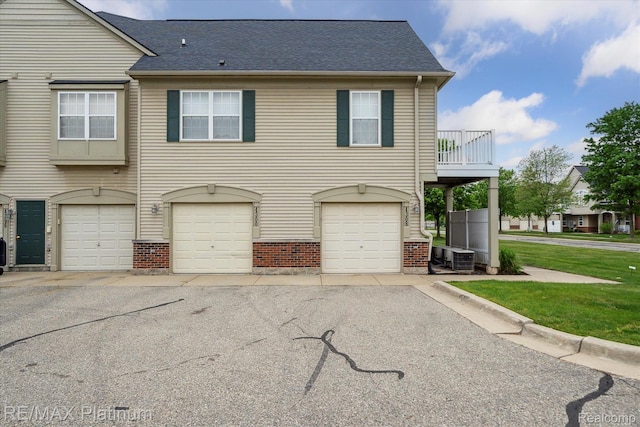 4300 Hampton Ridge Blvd, Howell, MI 48843 - view of property featuring a garage, brick siding, roof with shingles, and cooling unit
