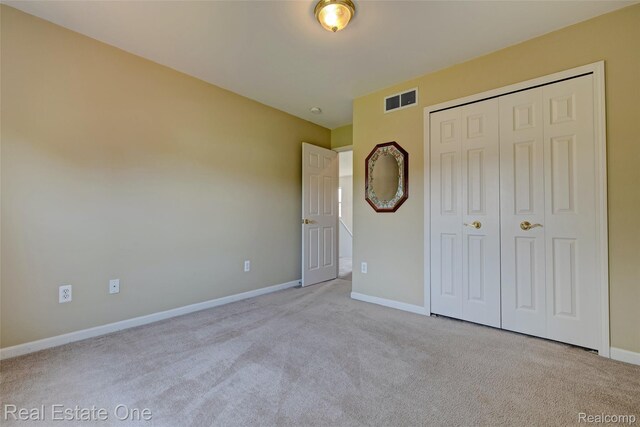 2338 Malena Ln, Oxford, MI 48371 - unfurnished bedroom featuring carpet flooring, baseboards, and a closet