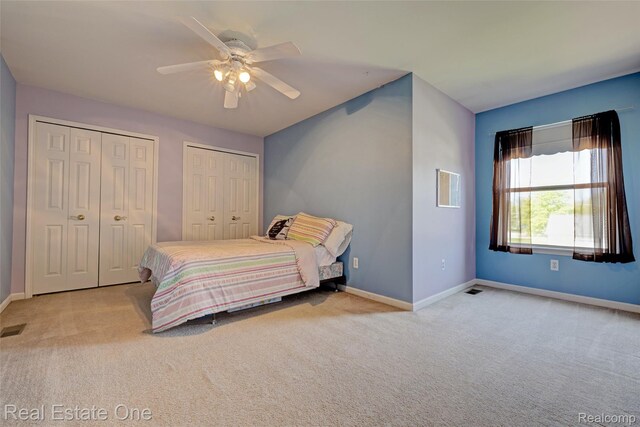 2338 Malena Ln, Oxford, MI 48371 - carpeted bedroom with multiple closets, baseboards, and a ceiling fan