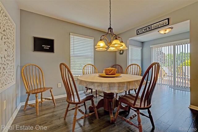 2338 Malena Ln, Oxford, MI 48371 - dining room featuring dark wood finished floors, baseboards, and a chandelier